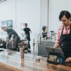 A man stands at the check-out in a coffee shop.